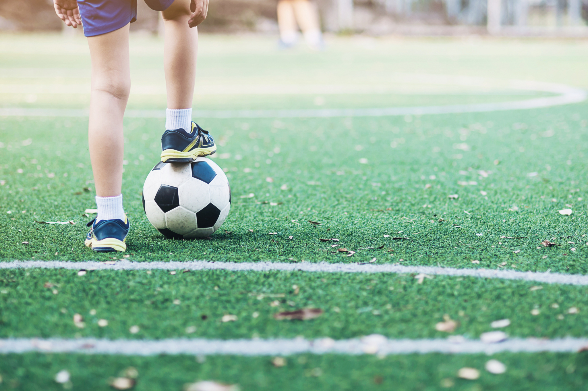 Boy standing with ball football field ready start play new game